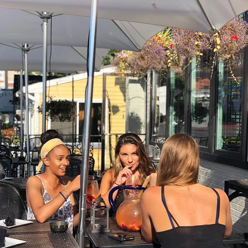 Guests enjoying sangria on Embargo's Main Street patio